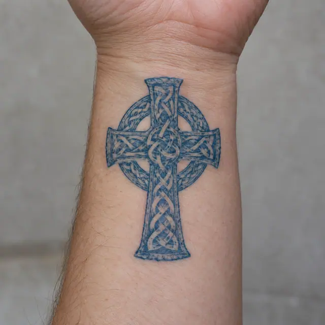 Woad blue Celtic cross tattoo on the wrist