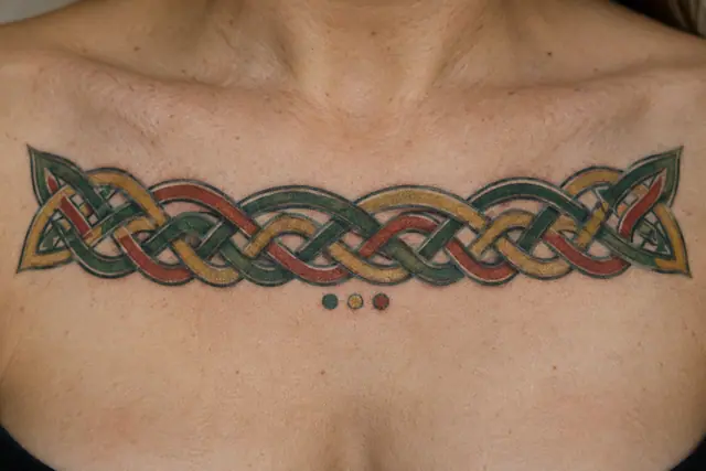 Color illuminated Celtic knot tattoo on the chest