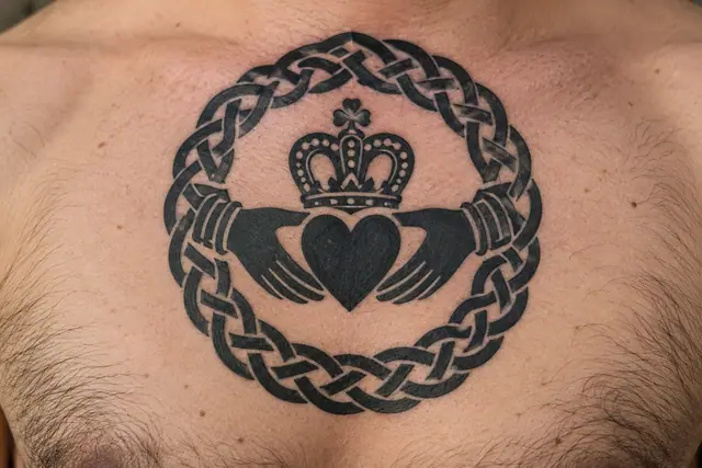 Blackwork Claddagh tattoo on the chest