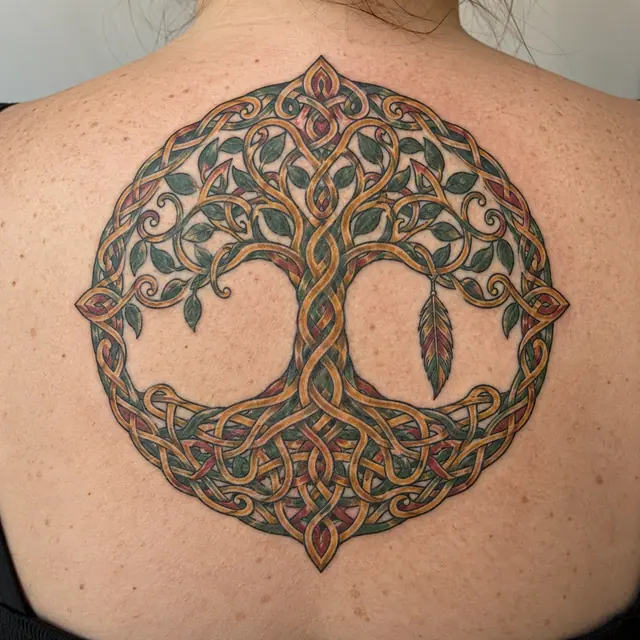 Color illuminated Celtic tree of life tattoo on the upper back